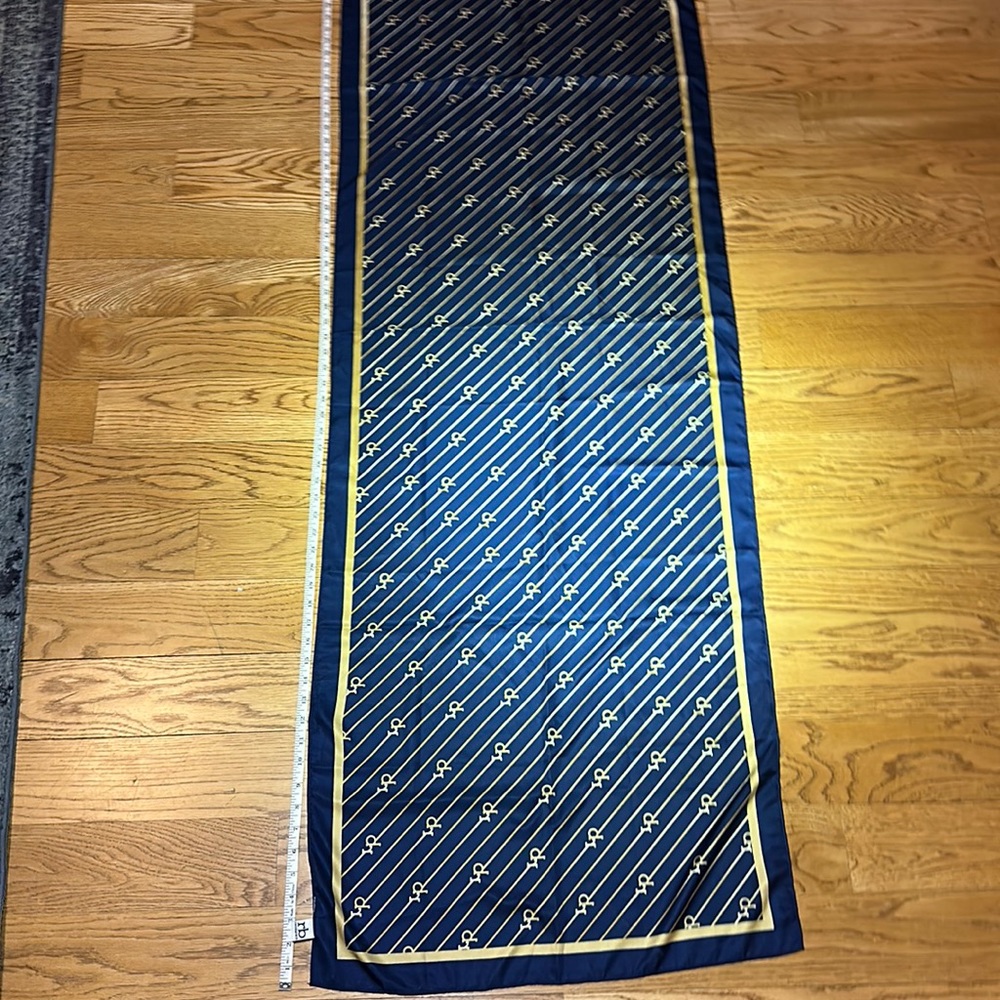Near new Rocco Barocco silk scarf. 68” x 22”. Gold and dark blue in color.